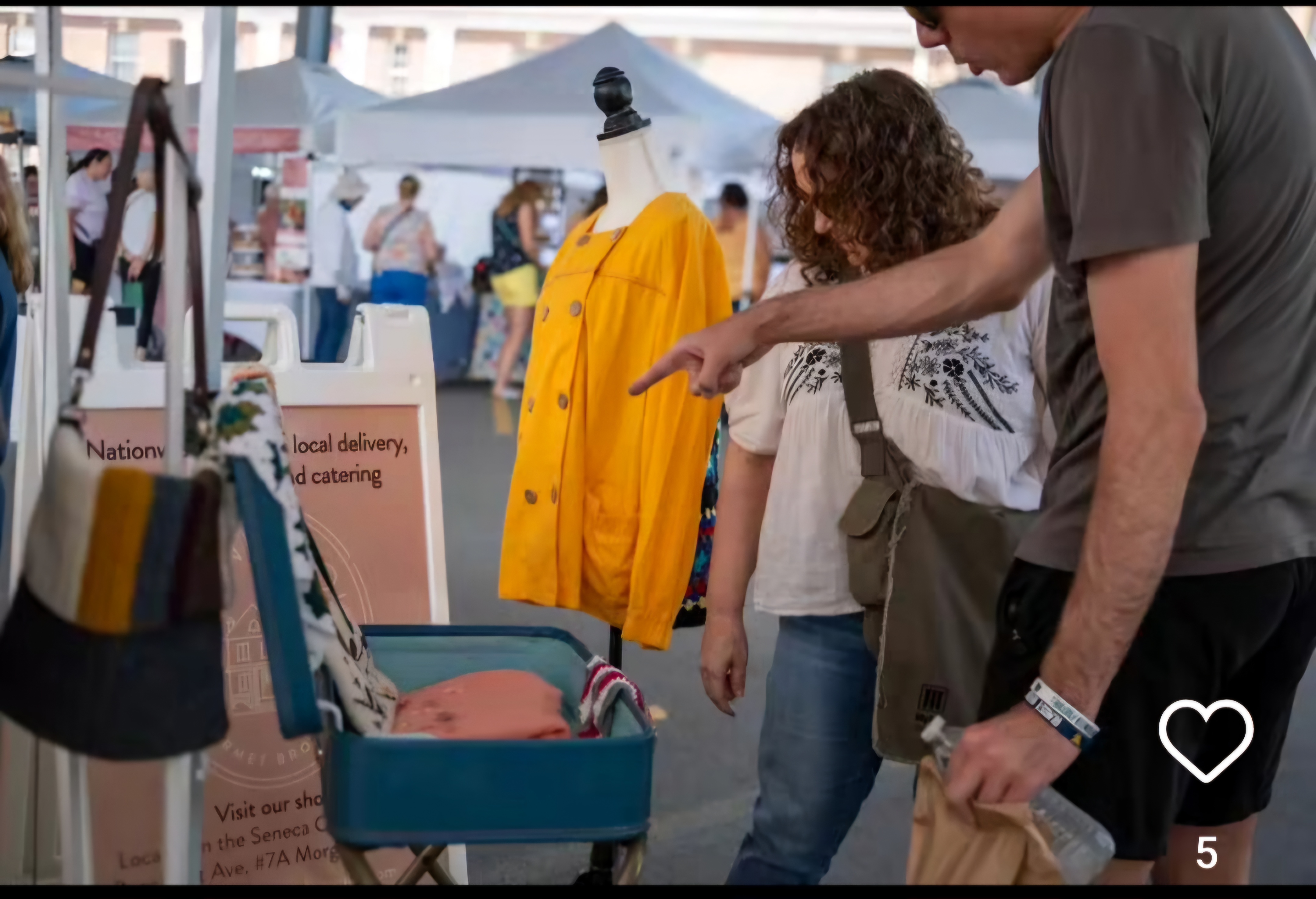 shoppers looking at items at open-air market